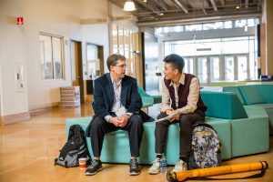 Two people talking at a conference