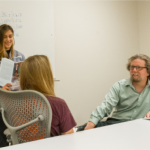 Faculty and students in a conference room