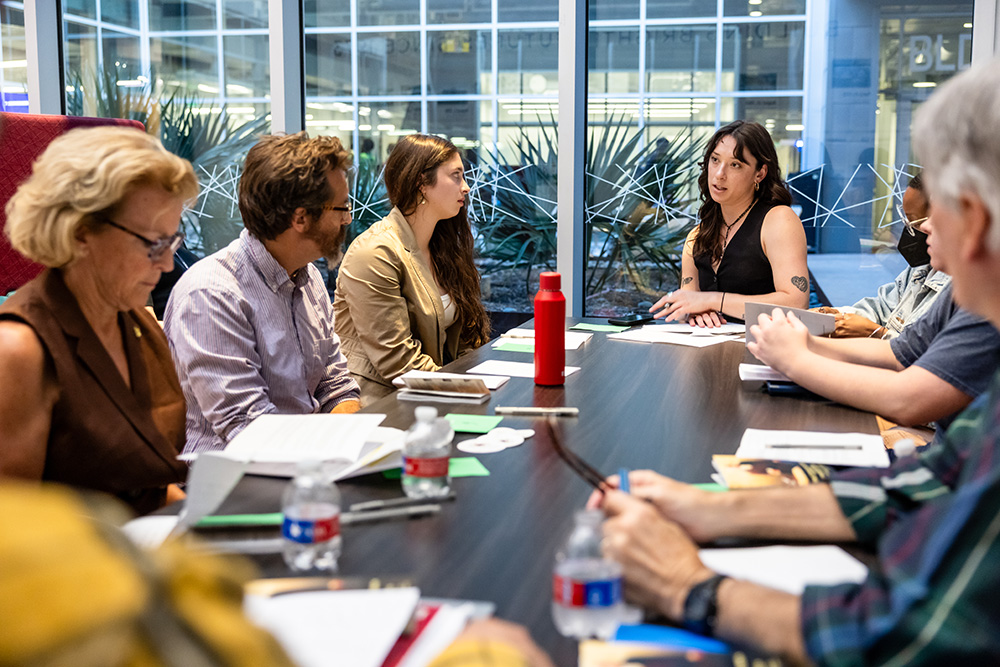 ACC students at Highland Campus discussing a reading around a table.
