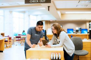 A librarian helping a student