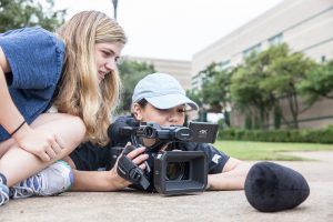 Students filming in a television production class