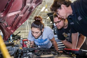 ACC auto tech students work on a car