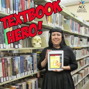 Textbook Hero Dr. Carleen Sanchez, Professor of Anthropology holding up a book in the library