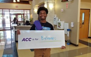 student holding ACC is for believers sign 