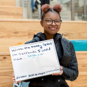 Student holding a sign